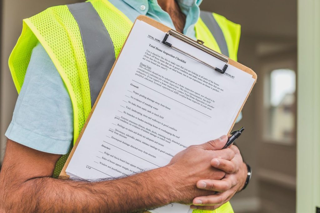 A written home inspection checklist being completed